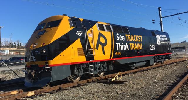 a locomotive painted with Operation Lifesaver logo and safety messages