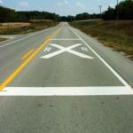 pavement marking showing railroad crossing ahead