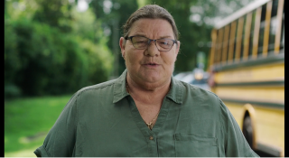 an image of a school bus driver next to her bus